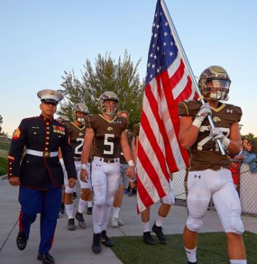 Football player holding US flag